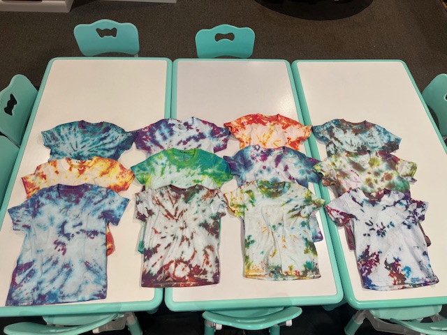 Finished tie-dye shirts drying on the tables