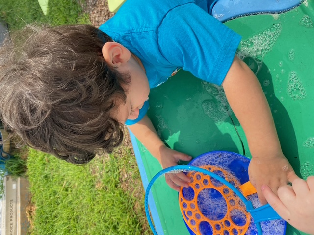 Making giant bubbles at the outdoor water table