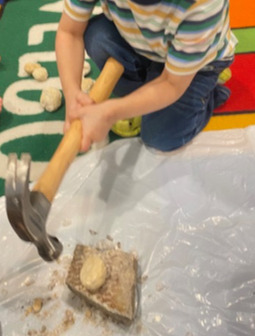 Cracking open a geode with a hammer during science time