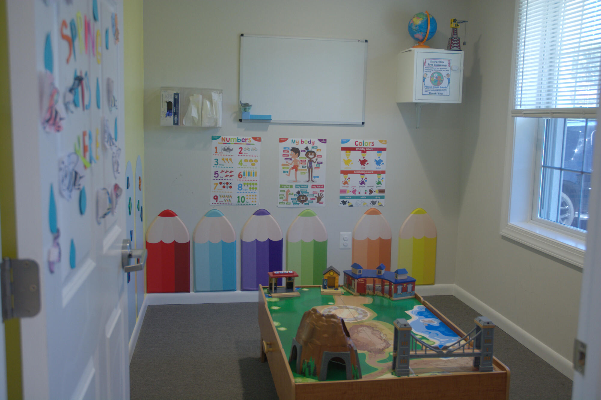 Classroom with learning charts and a wooden train table