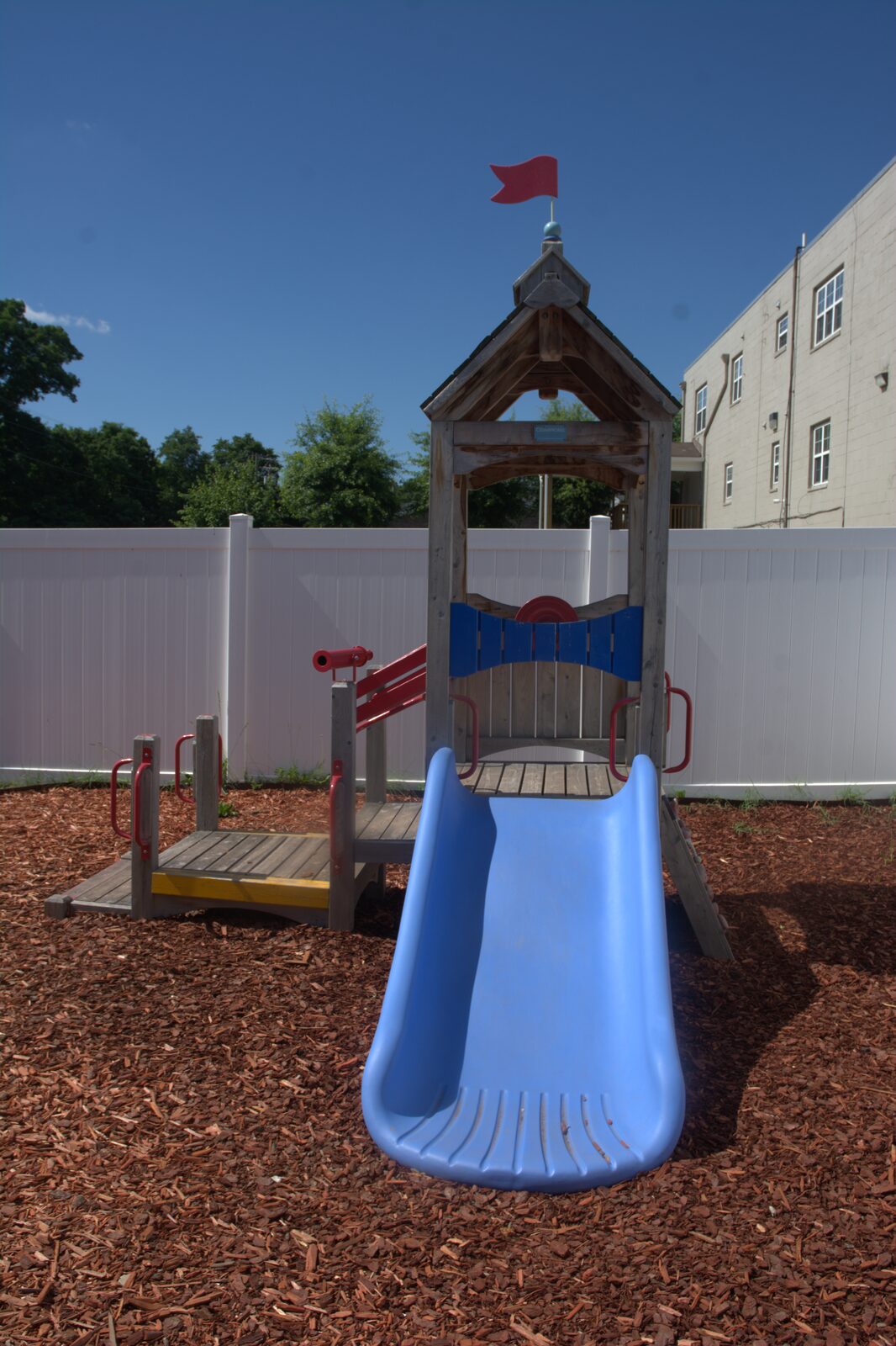 Outdoor playground climber with a blue slide