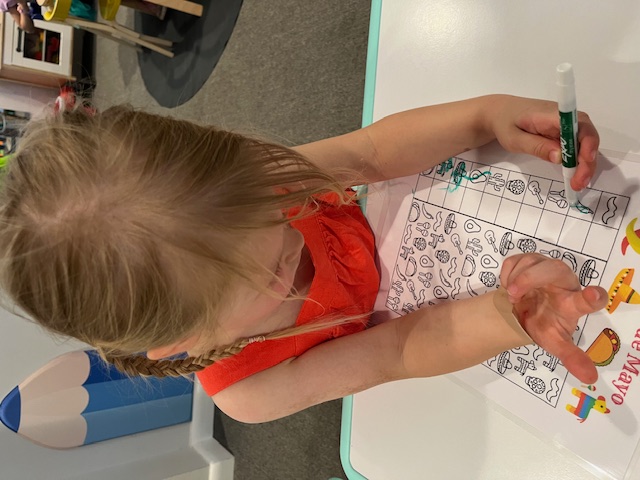 Coloring a Cinco de Mayo activity page with markers